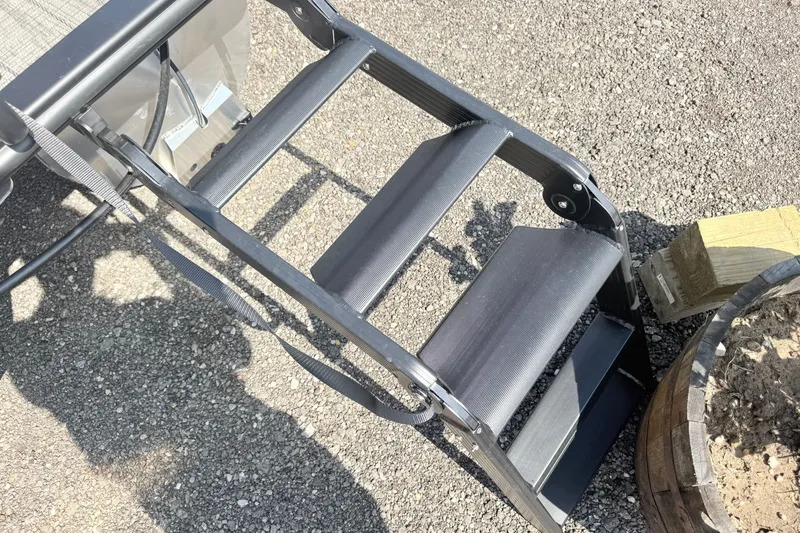 Slide: The Image of Bentley Pontoons Legacy 220 Navigator 2026 boat ladder on gravel surface. - 9