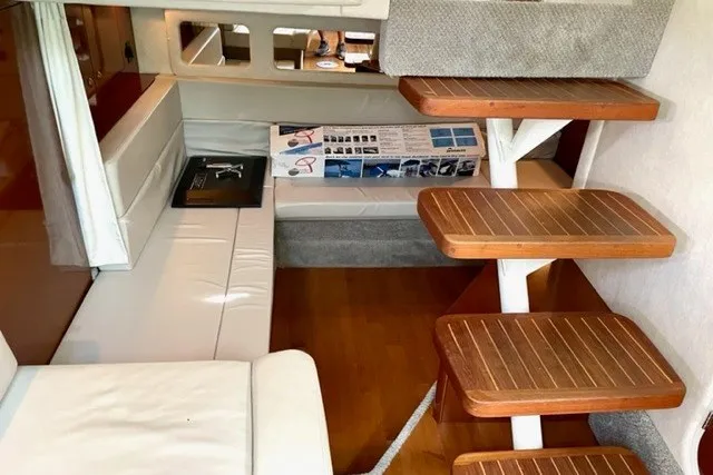 Slide: The Image of Interior of 2008 Sea Ray Sundancer 330 yacht with wooden steps and white seating. - 26