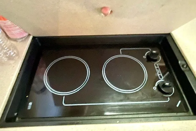 Slide: The Image of Stovetop in 2008 Sea Ray Sundancer 330 yacht kitchen, featuring dual burners and control knobs. - 22