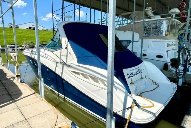 The Image of 2008 Sea Ray Sundancer 330 docked in marina, blue and white exterior. - 4