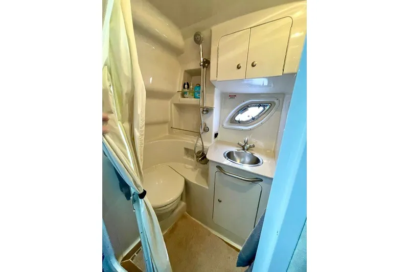 Slide: The Image of Compact bathroom in 2008 Sea Ray Sundancer 330 yacht with shower, sink, and storage. - 27