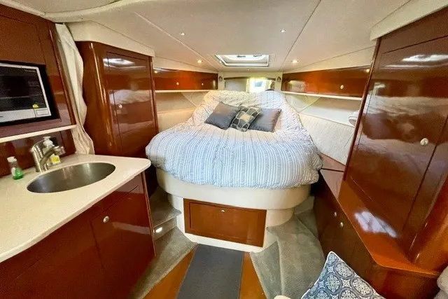Slide: The Image of Interior of 2008 Sea Ray Sundancer 330 yacht with cozy bed and kitchenette. - 17