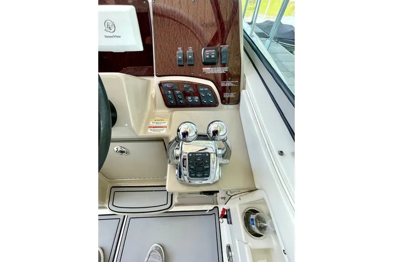 Slide: The Image of Control panel of a 2008 Sea Ray Sundancer 330 boat, featuring throttle and switches. - 14