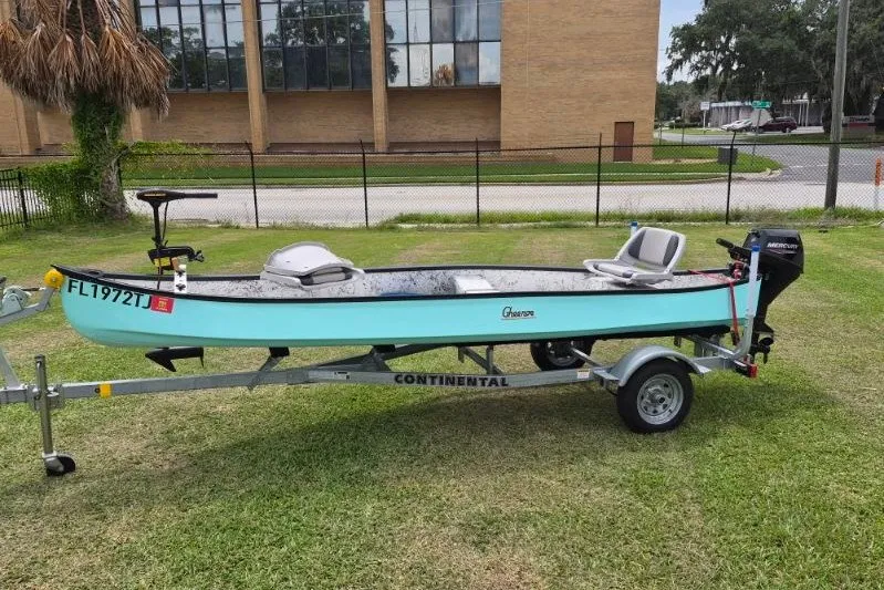 The Image of 2022 Gheenoe NMZ 15.4 boat on trailer, parked on grass near a building. - 1
