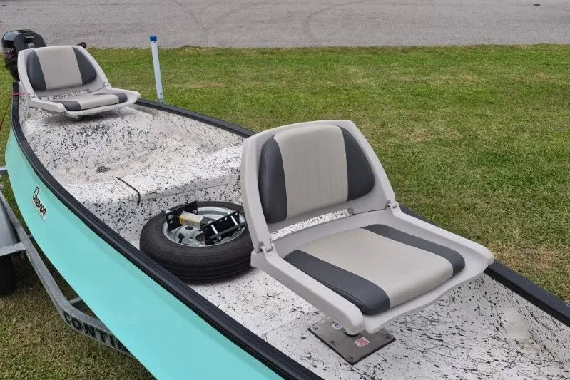 Slide: The Image of 2022 Gheenoe NMZ 15.4 boat with dual seats on a grassy area. - 9