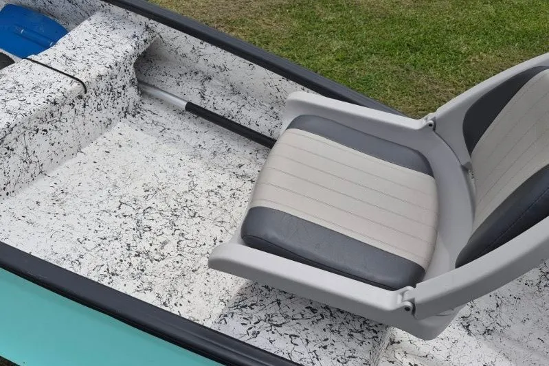 Slide: The Image of 2022 Gheenoe NMZ 15.4 boat interior with swivel seat and textured flooring. - 13
