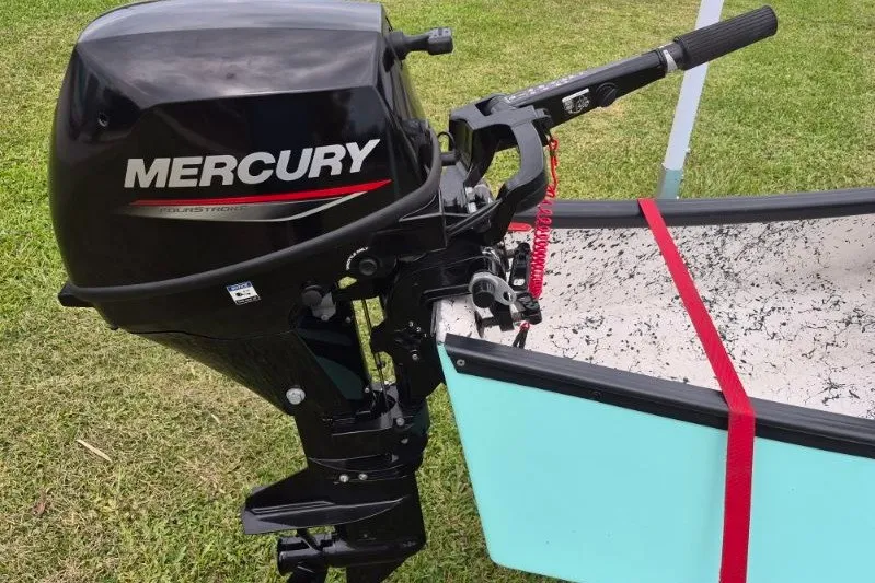 Slide: The Image of 2022 Gheenoe NMZ 15.4 with Mercury outboard motor on grassy background. - 14
