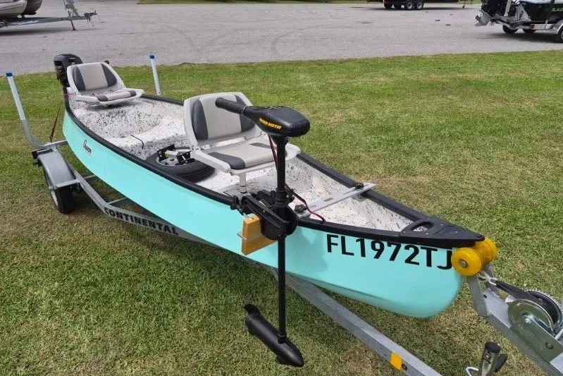 Slide: The Image of 2022 Gheenoe NMZ 15.4 boat on trailer, featuring two seats and a trolling motor. - 3