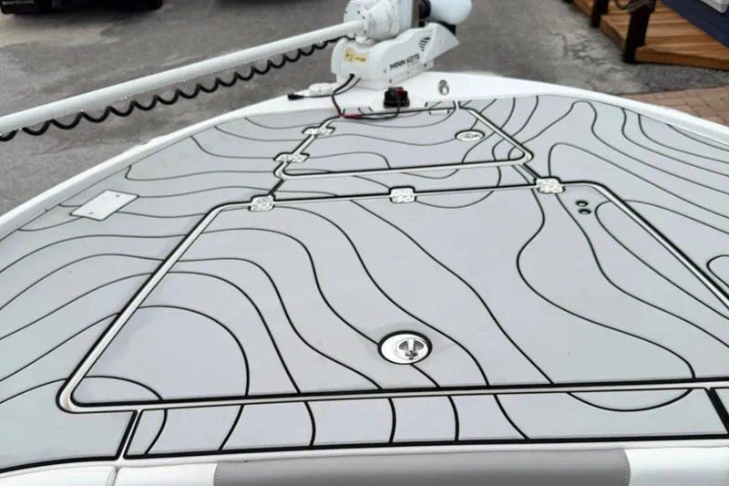 Slide: The Image of 2023 Caymas 26 HB boat deck with sleek, modern design and contour lines. - 17