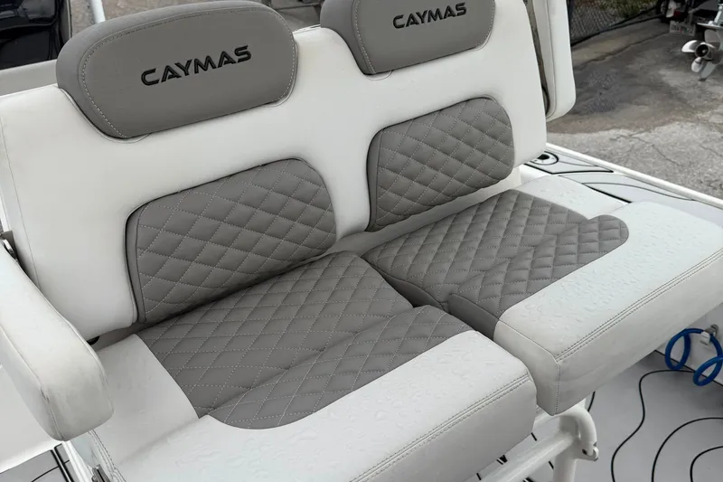 Slide: The Image of 2023 Caymas 26 HB boat seats with gray quilted upholstery and branding. - 11