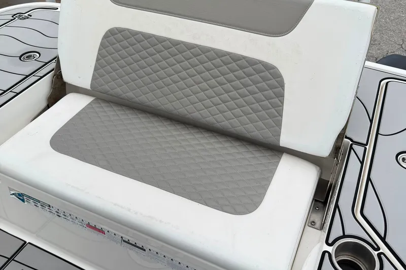 Slide: The Image of Gray and white cushioned seat on 2023 Caymas 26 HB boat. - 8