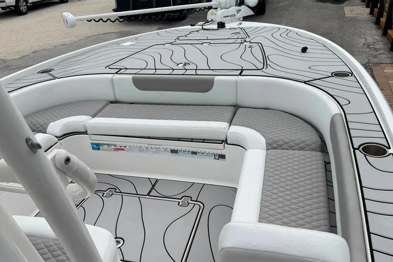 Slide: The Image of 2023 Caymas 26 HB boat interior with gray seating and patterned flooring. - 12