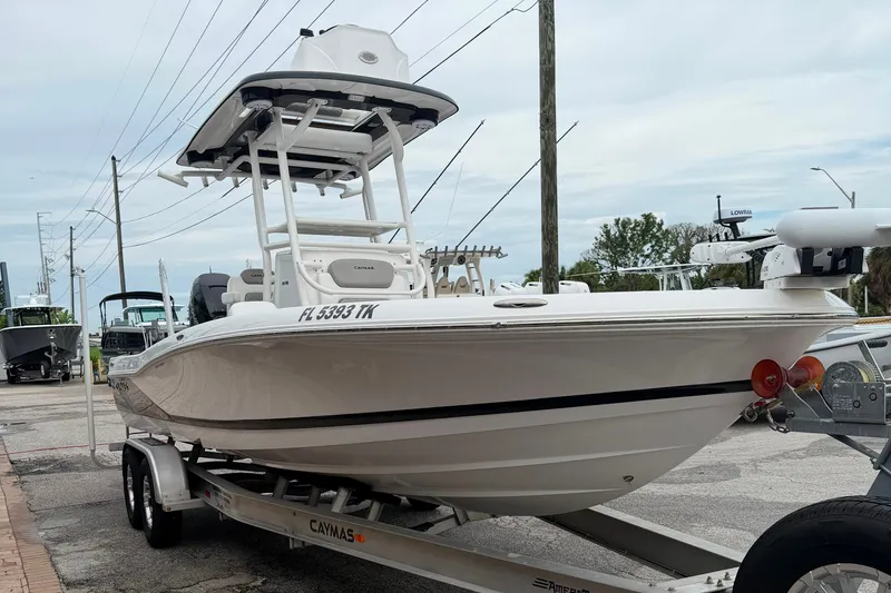 Slide: The Image of 2023 Caymas 26 HB boat on trailer, white hull, parked outdoors. - 4