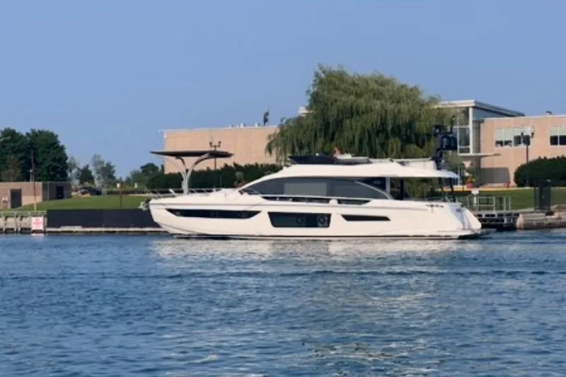 Slide: The Image of 2023 Azimut Fly 68 yacht on calm water near modern buildings. - 116