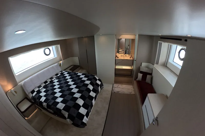 Slide: The Image of Luxurious bedroom interior of 2023 Azimut Fly 68 yacht with modern design and checkered bedding. - 81