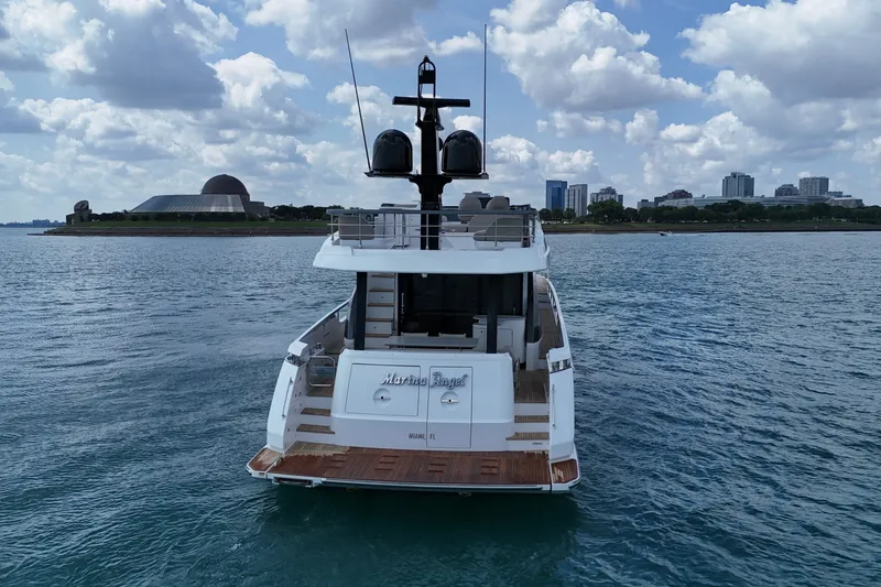 Slide: The Image of 2023 Azimut Fly 68 yacht on water with city skyline backdrop. - 10
