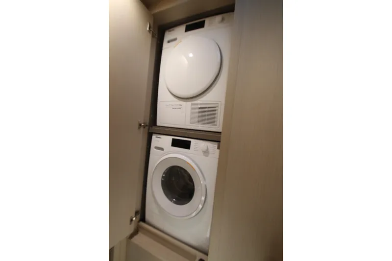 Slide: The Image of Stacked washer and dryer in 2023 Azimut Fly 68 yacht interior. - 75