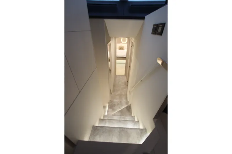 Slide: The Image of Interior staircase of 2023 Azimut Fly 68 yacht, featuring modern design and ambient lighting. - 71