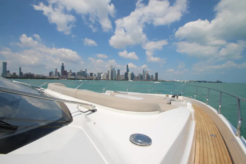 Slide: The Image of 2023 Azimut Fly 68 yacht cruising with city skyline in the background. - 30