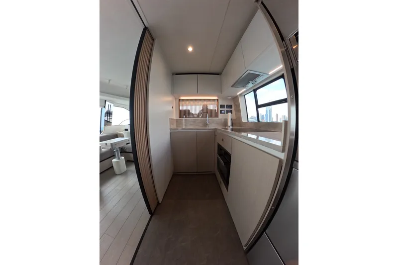 Slide: The Image of Modern kitchen interior of 2023 Azimut Fly 68 yacht, featuring sleek design and panoramic windows. - 53