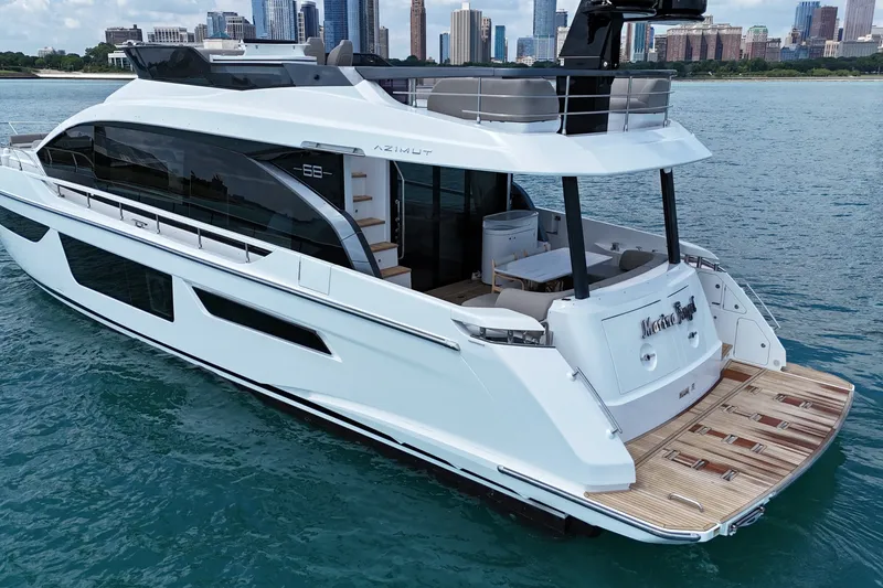 Slide: The Image of Luxury 2023 Azimut Fly 68 yacht cruising near city skyline. - 3