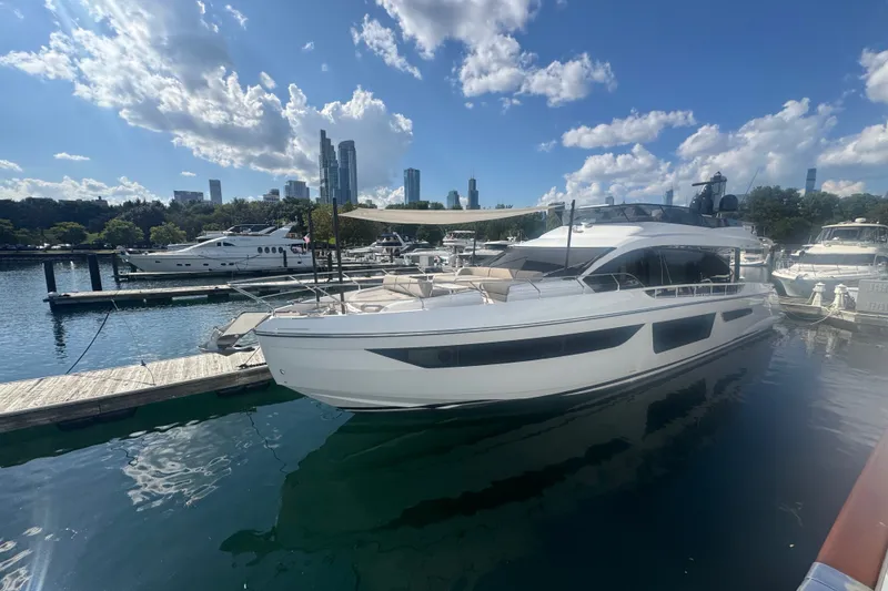 Slide: The Image of Luxury 2023 Azimut Fly 68 yacht docked in a marina under a blue sky. - 182