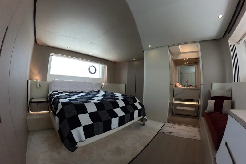 Slide: The Image of Luxurious bedroom interior of 2023 Azimut Fly 68 yacht with modern design and checkered bedding. - 82