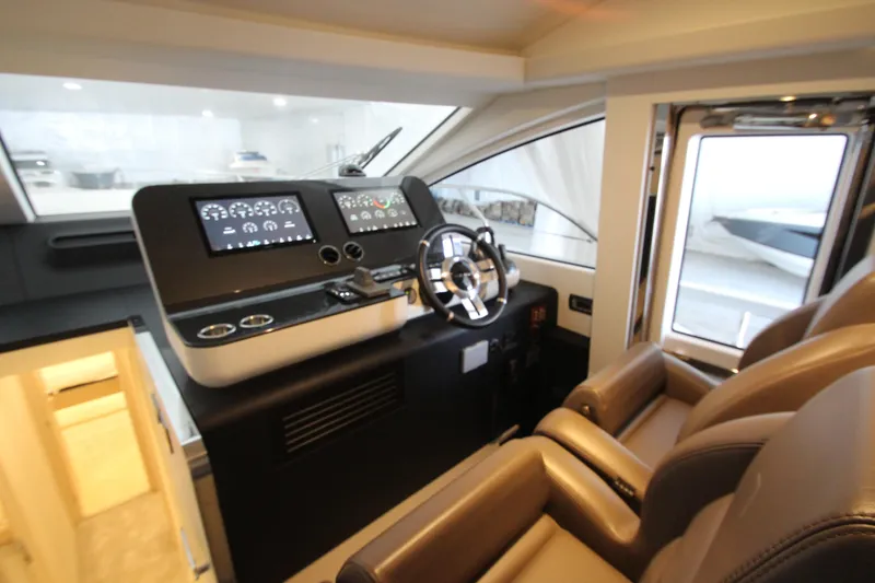Slide: The Image of Luxurious helm of 2023 Azimut Fly 68 yacht with modern controls and leather seating. - 61