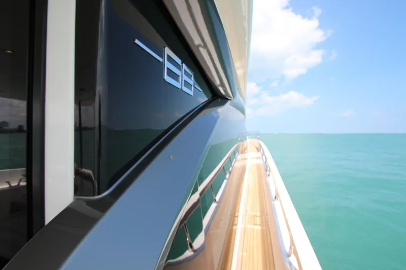 Slide: The Image of 2023 Azimut Fly 68 yacht cruising on clear blue ocean waters. - 31