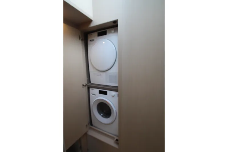 Slide: The Image of Stacked washer and dryer in 2023 Azimut Fly 68 yacht interior. - 76