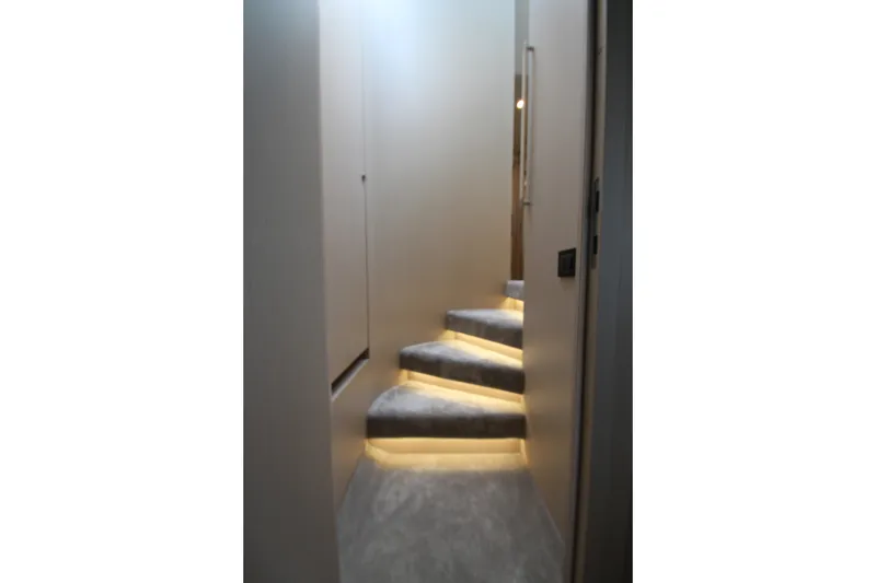 Slide: The Image of Modern staircase with ambient lighting inside 2023 Azimut Fly 68 yacht. - 72