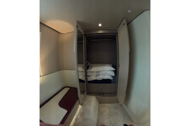 Slide: The Image of Interior of 2023 Azimut Fly 68 yacht with open wardrobe and bedding. - 82