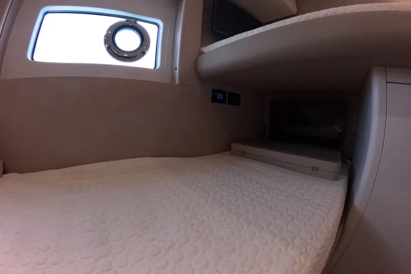 Slide: The Image of Interior cabin of 2023 Azimut Fly 68 yacht with cozy bedding and porthole window. - 96