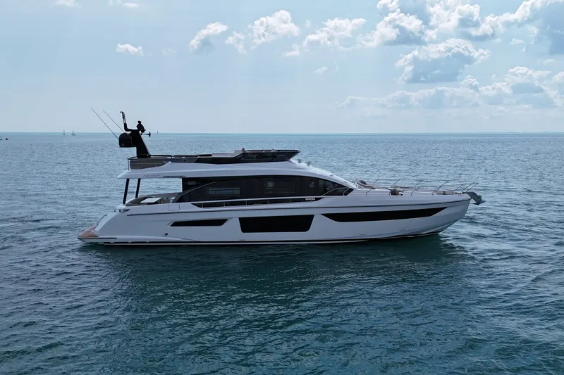 Slide: The Image of 2023 Azimut Fly 68 yacht cruising on open sea under a partly cloudy sky. - 12