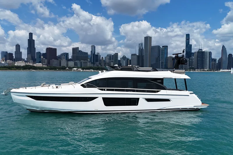 Slide: The Image of 2023 Azimut Fly 68 yacht cruising on a city waterfront with skyscrapers in the background. - 5