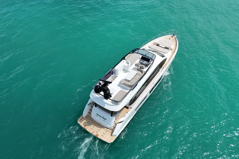 Slide: The Image of 2023 Azimut Fly 68 yacht cruising on turquoise waters, aerial view. - 4