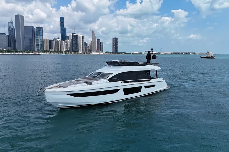 Slide: The Image of 2023 Azimut Fly 68 yacht cruising near a city skyline on a sunny day. - 1
