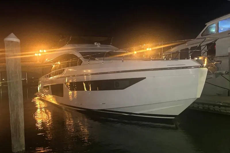 Slide: The Image of Luxurious 2023 Azimut Fly 68 yacht docked at night, illuminated by warm lights. - 125