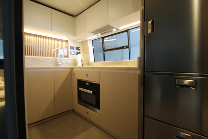 Slide: The Image of Modern kitchen interior of 2023 Azimut Fly 68 yacht, featuring sleek cabinetry and appliances. - 51