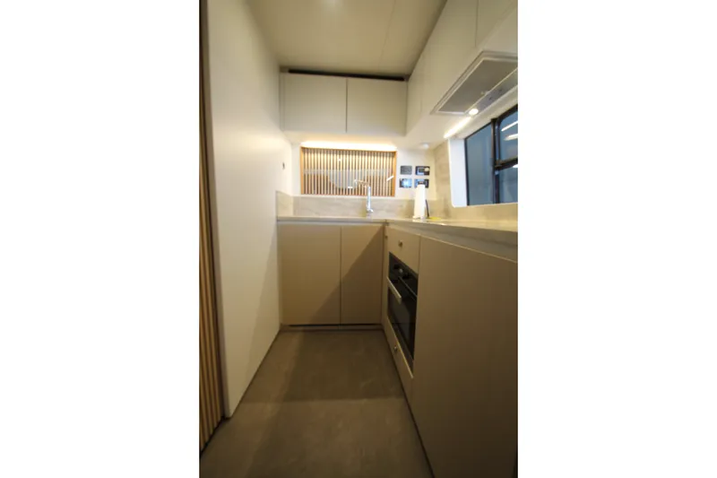 Slide: The Image of Modern kitchen interior in 2023 Azimut Fly 68 yacht, featuring sleek cabinetry and appliances. - 52