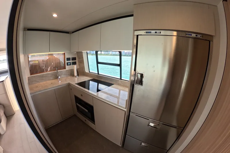 Slide: The Image of Modern kitchen interior of 2023 Azimut Fly 68 yacht with sleek appliances and ocean view. - 50