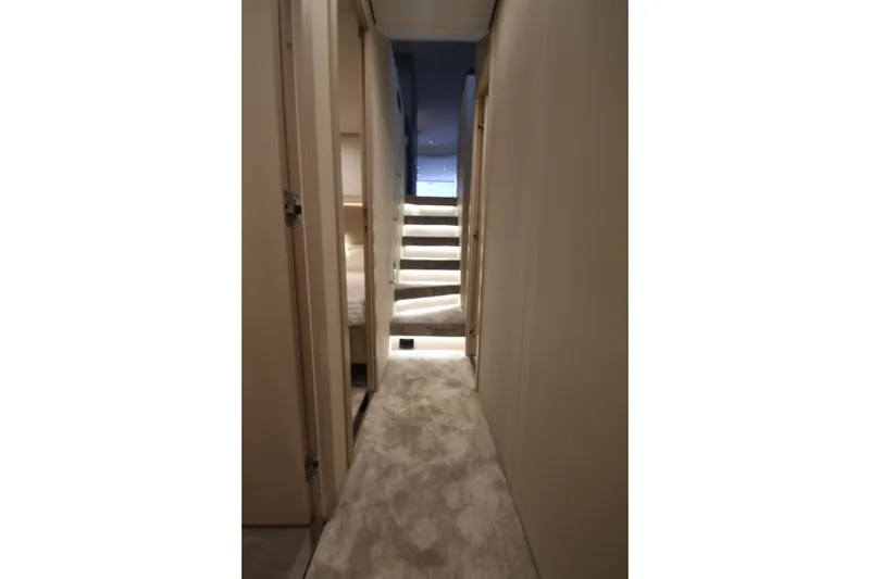 Slide: The Image of Luxurious interior hallway of 2023 Azimut Fly 68 yacht with carpeted flooring and stairs. - 103