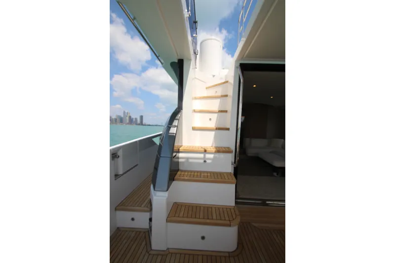 Slide: The Image of Staircase on 2023 Azimut Fly 68 yacht with ocean view and city skyline. - 33