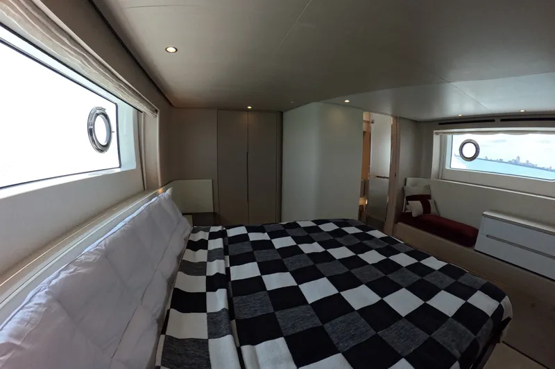 Slide: The Image of Luxurious bedroom interior of 2023 Azimut Fly 68 yacht with checkered bedding and ocean view. - 85