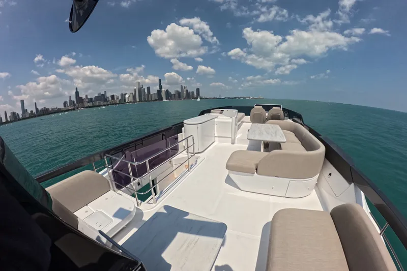 Slide: The Image of Luxurious 2023 Azimut Fly 68 yacht with city skyline and blue ocean backdrop. - 34