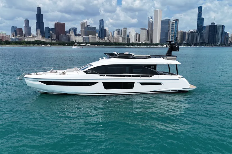 Slide: The Image of 2023 Azimut Fly 68 yacht cruising on blue water with city skyline backdrop. - 15
