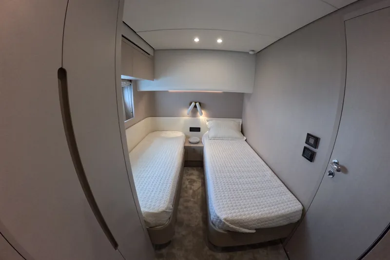 Slide: The Image of Luxurious twin cabin interior of 2023 Azimut Fly 68 yacht, featuring modern design and lighting. - 97