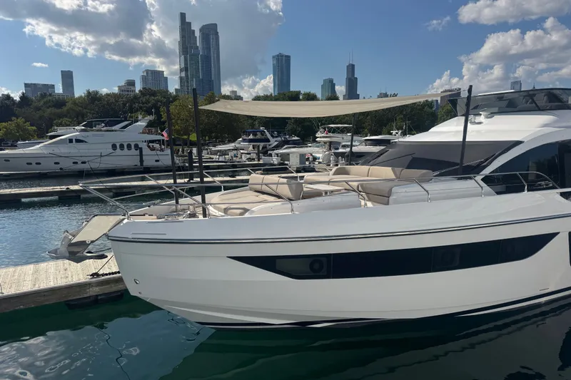 Slide: The Image of Luxury Azimut Fly 68 yacht docked in marina, city skyline in background, 2023 model. - 183