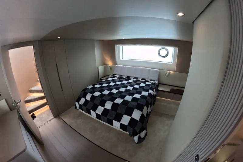 Slide: The Image of Luxurious bedroom interior of 2023 Azimut Fly 68 yacht with modern design and checkered bedding. - 78