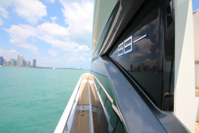 Slide: The Image of Azimut Fly 68 yacht cruising with city skyline in the background, 2023 model. - 23